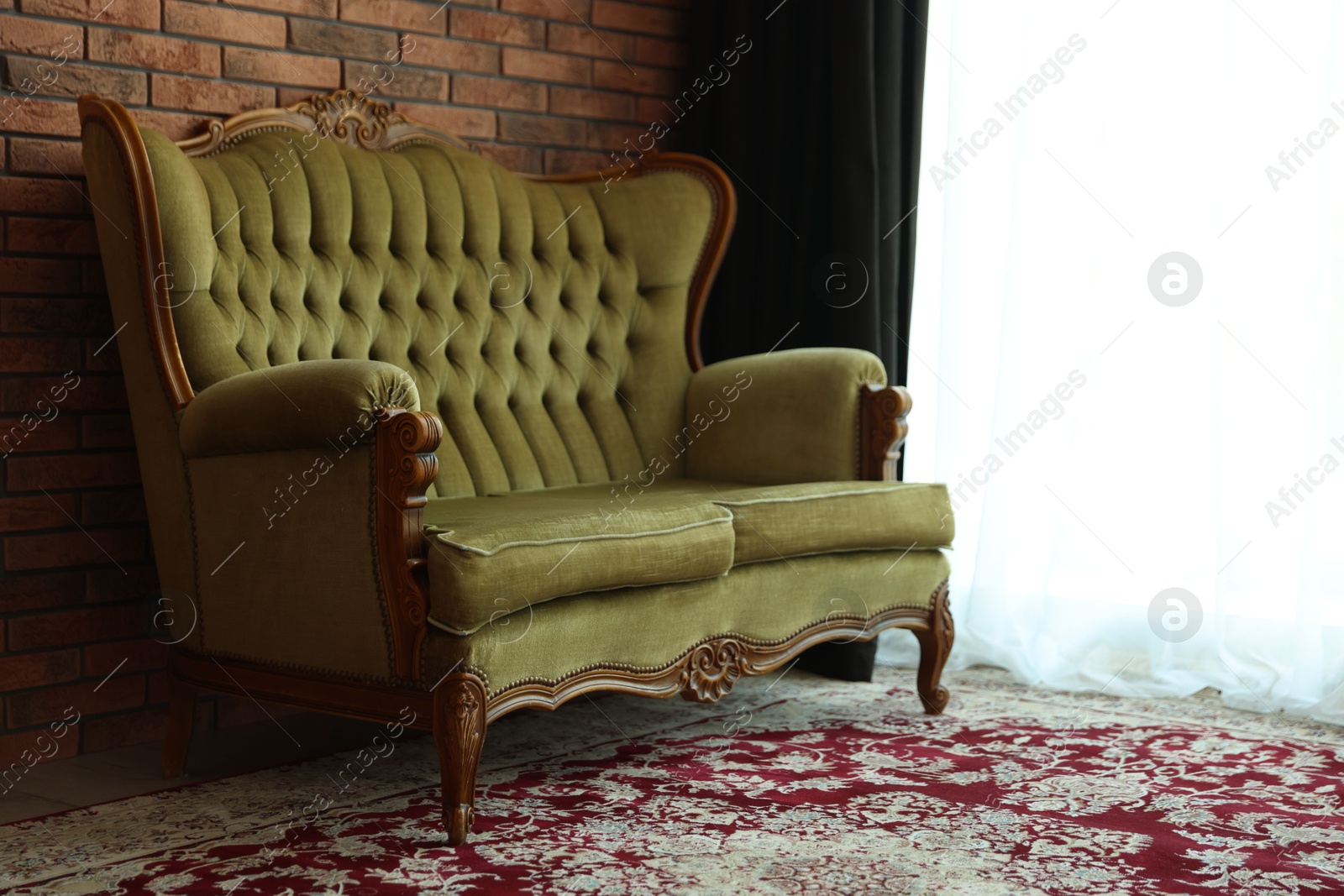 Green retro sofa in room. Interior design Photo of Green retro sofa in room. Interior design