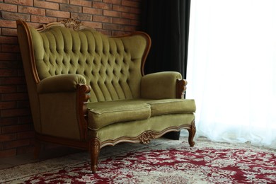 Photo of Green retro sofa in room. Interior design