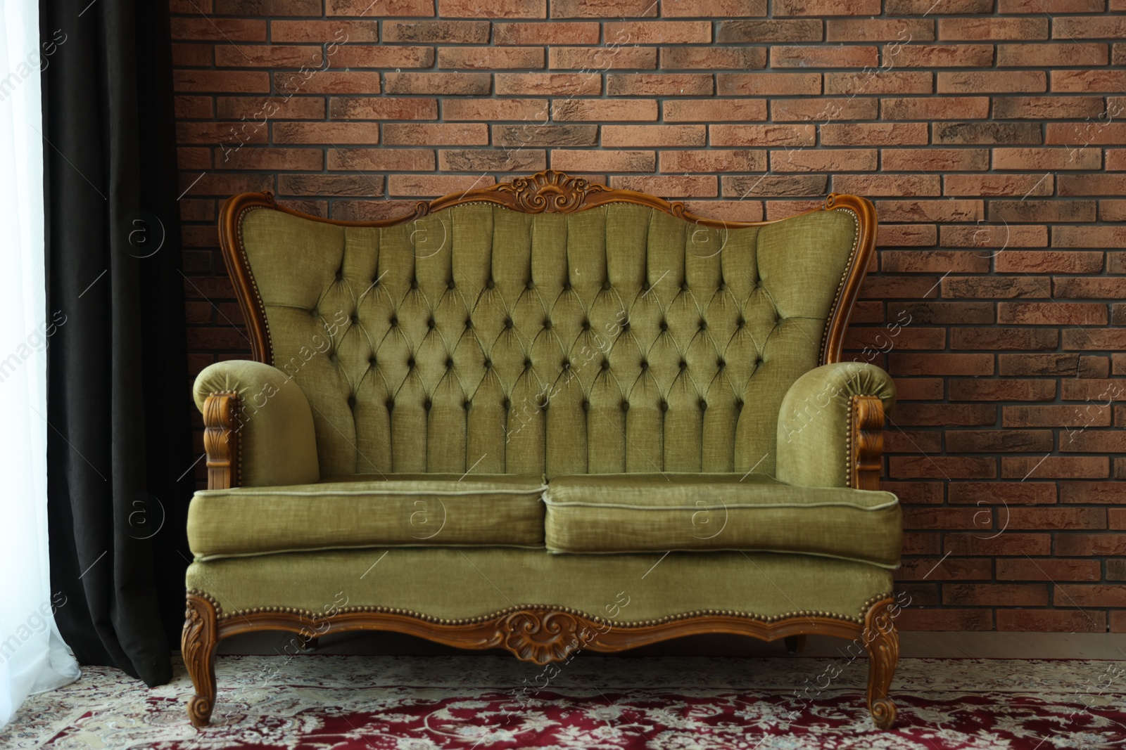 Photo of Green retro sofa in room. Interior design
