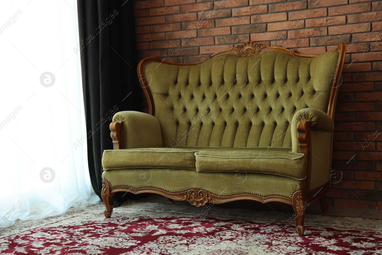 Photo of Green retro sofa in room. Interior design