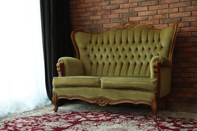 Photo of Green retro sofa in room. Interior design