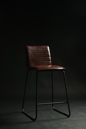 Photo of Bar stool on black background. Used stuff