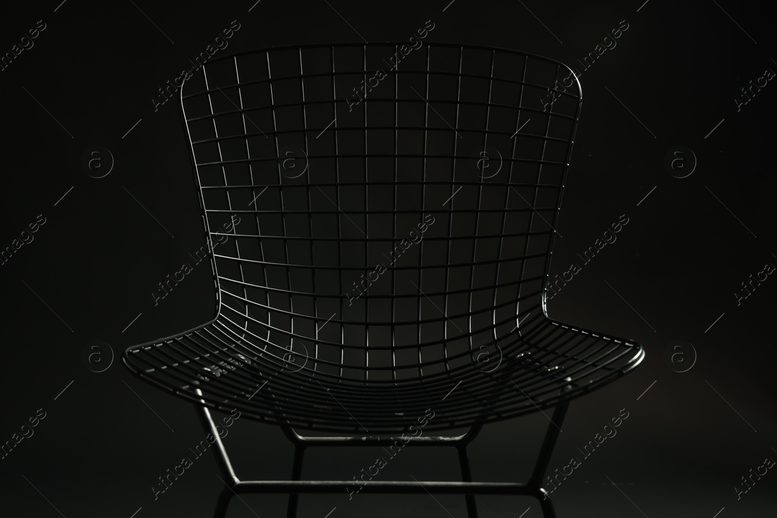Photo of Stylish chair on black background, closeup. Used stuff