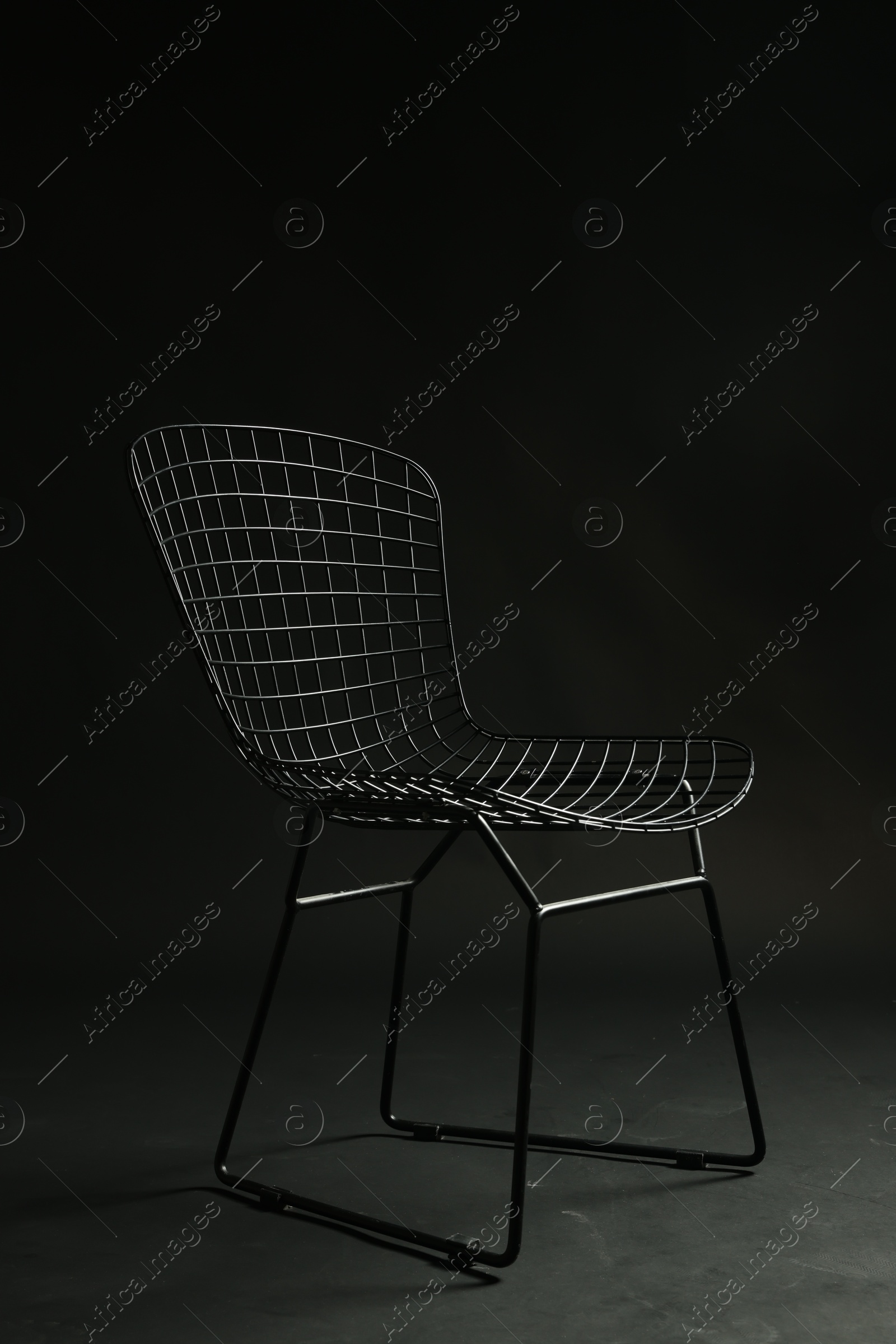 Photo of Stylish chair on black background. Used stuff