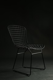 Photo of Stylish chair on black background. Used stuff