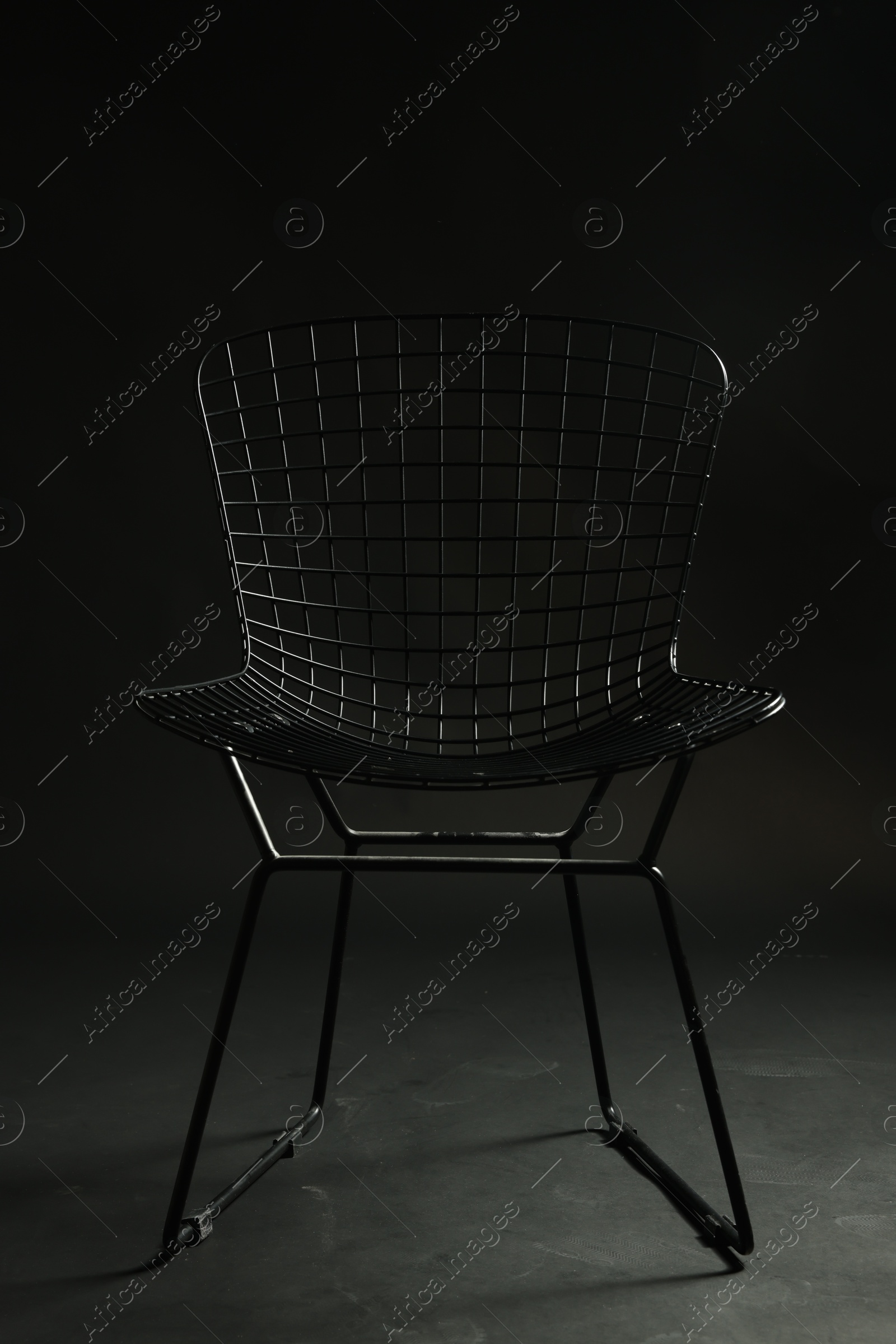 Photo of Stylish chair on black background, closeup. Used stuff