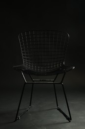 Photo of Stylish chair on black background, closeup. Used stuff