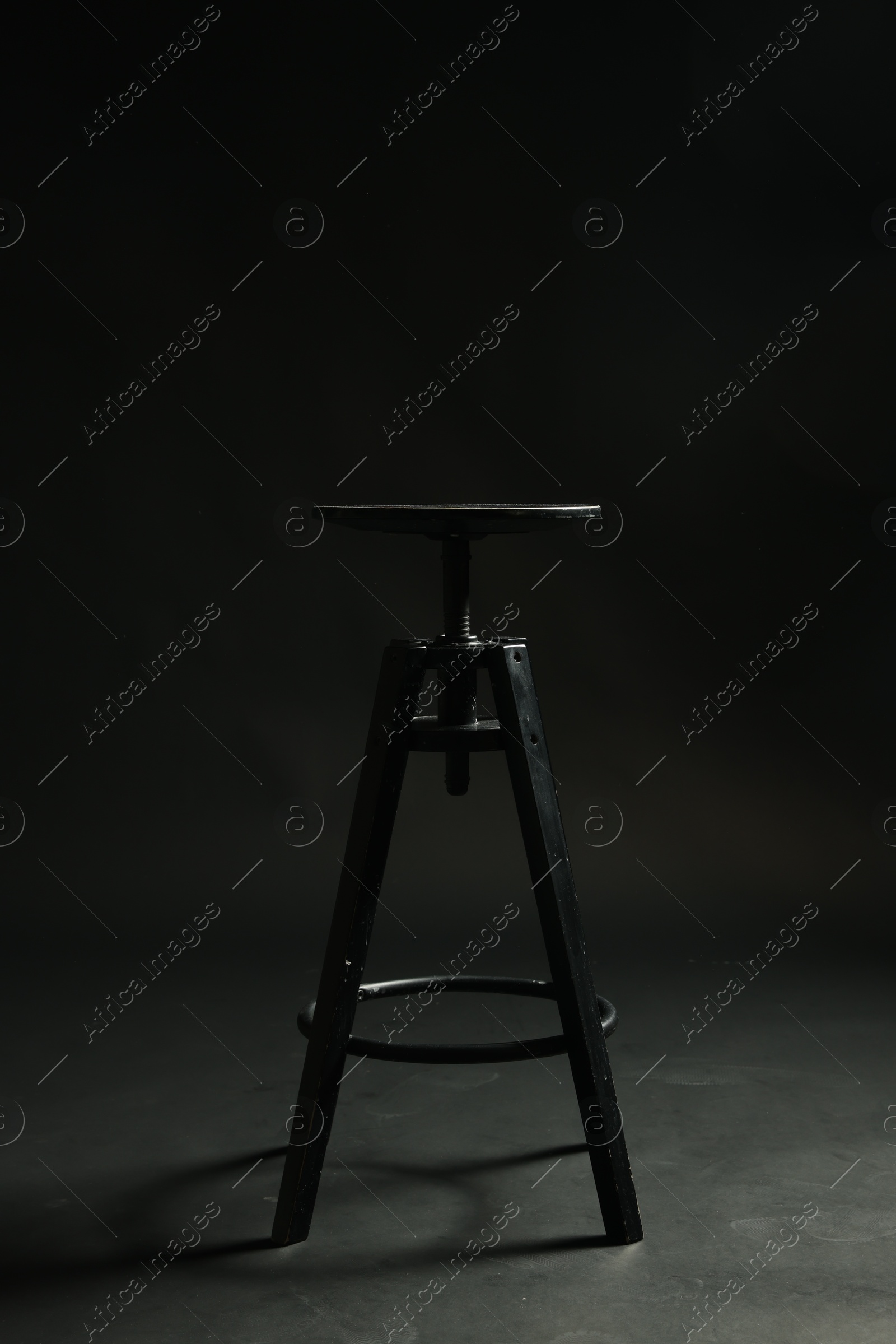 Photo of Bar stool on black background. Used stuff