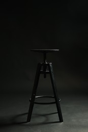 Photo of Bar stool on black background. Used stuff