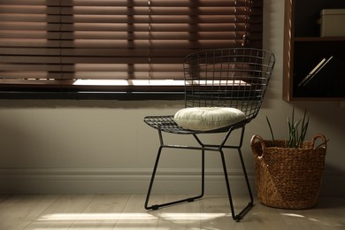 Photo of Stylish chair and other used stuff near window indoors, space for text