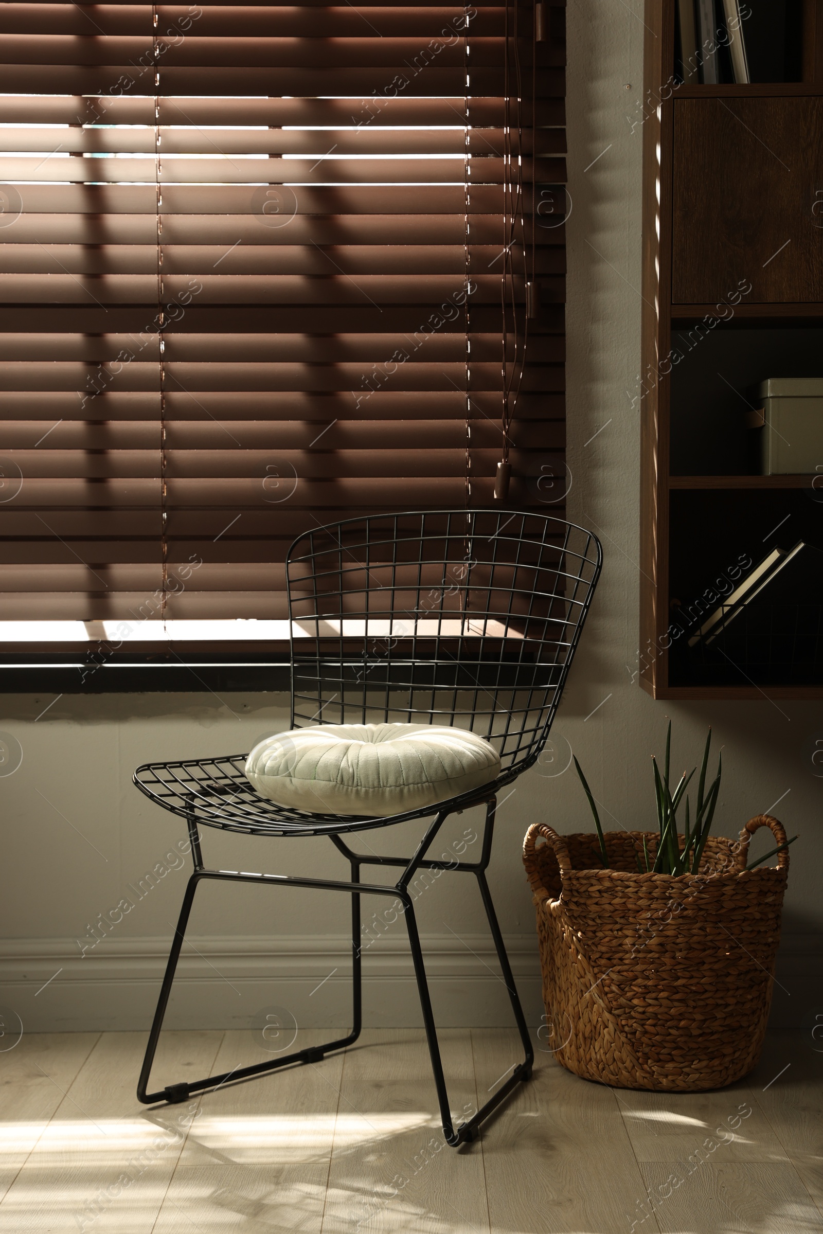 Photo of Stylish chair and other used stuff near window indoors