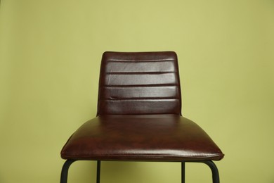 Photo of One bar stool on olive background, closeup. Used stuff