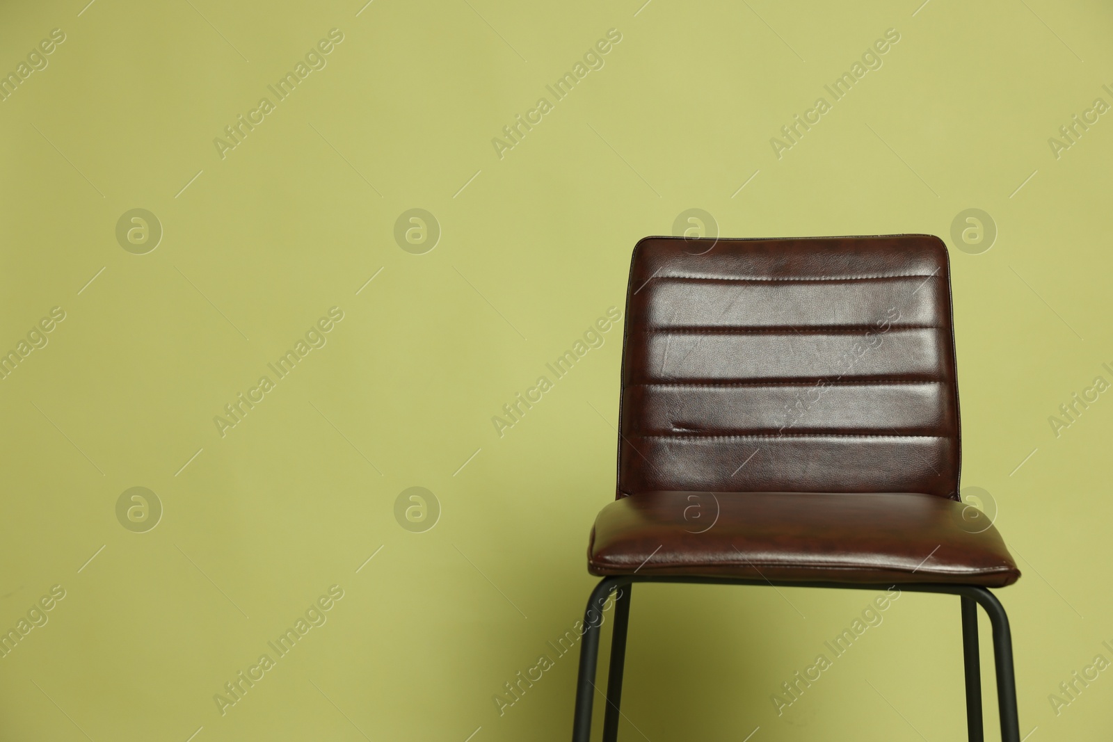 Photo of One bar stool on olive background, space for text. Used stuff