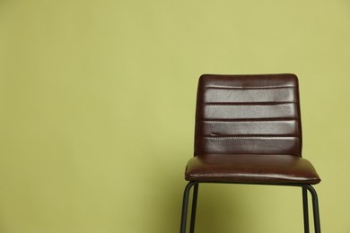 Photo of One bar stool on olive background, space for text. Used stuff