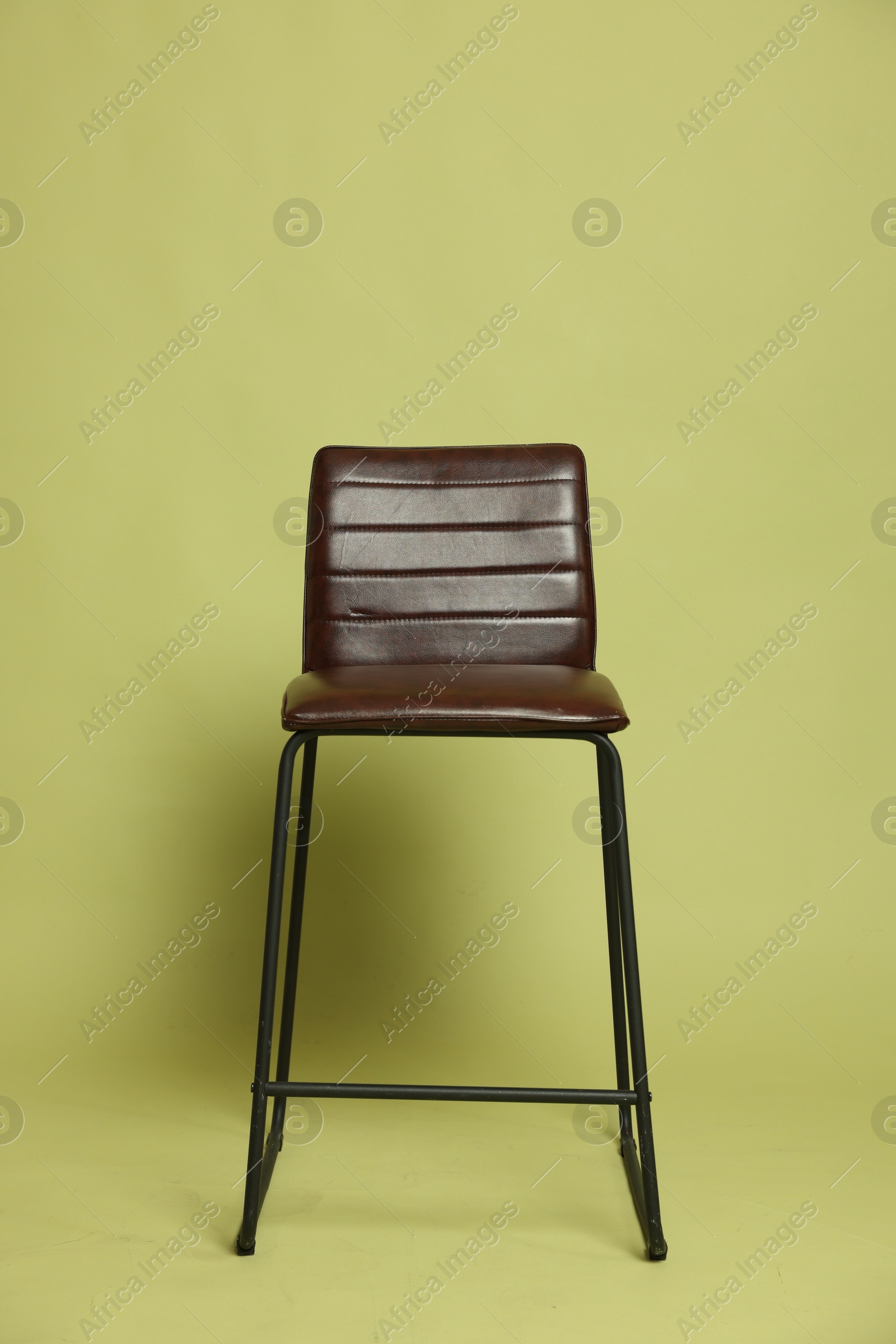 Photo of One bar stool on olive background. Used stuff