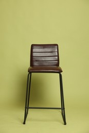 Photo of One bar stool on olive background. Used stuff