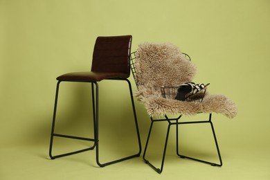 Photo of Bar stool, chair and shoes on olive background. Used stuff