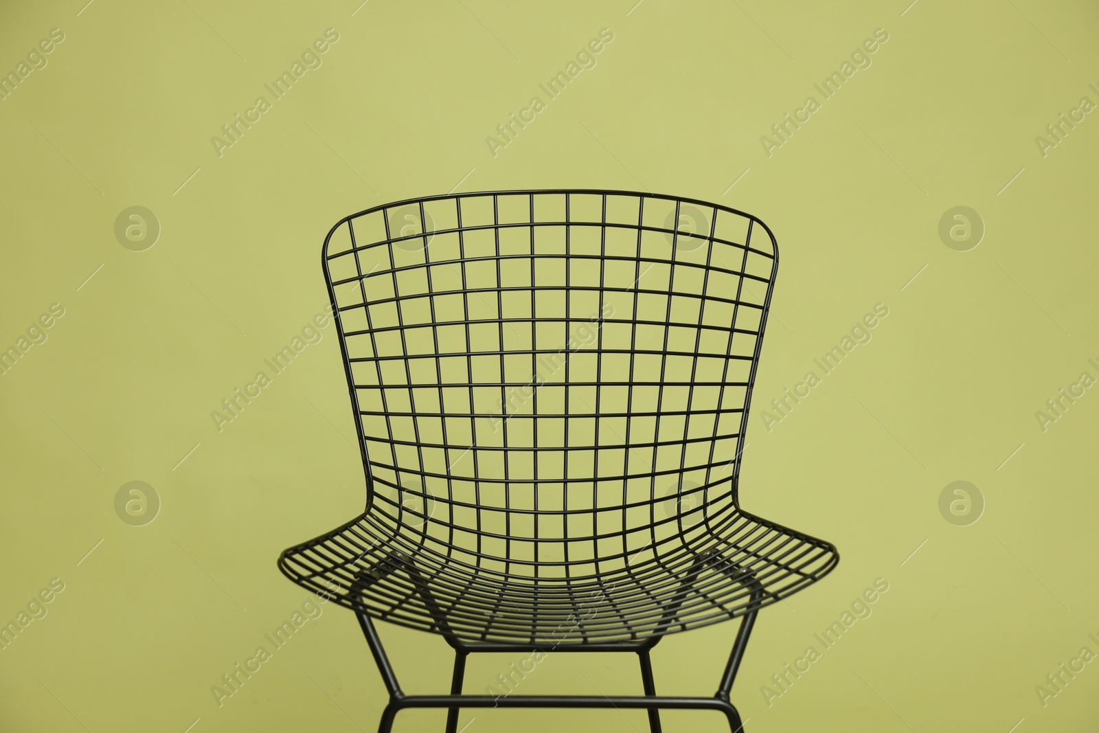 Photo of Stylish chair on olive background, closeup. Used stuff