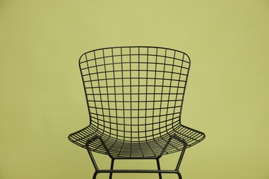 Photo of Stylish chair on olive background, closeup. Used stuff