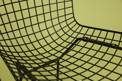 Photo of Stylish chair on olive background, closeup. Used stuff