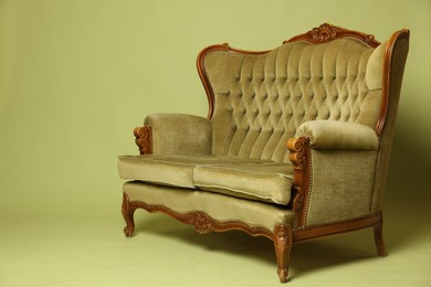 Photo of Soft sofa on olive background, space for text. Used stuff