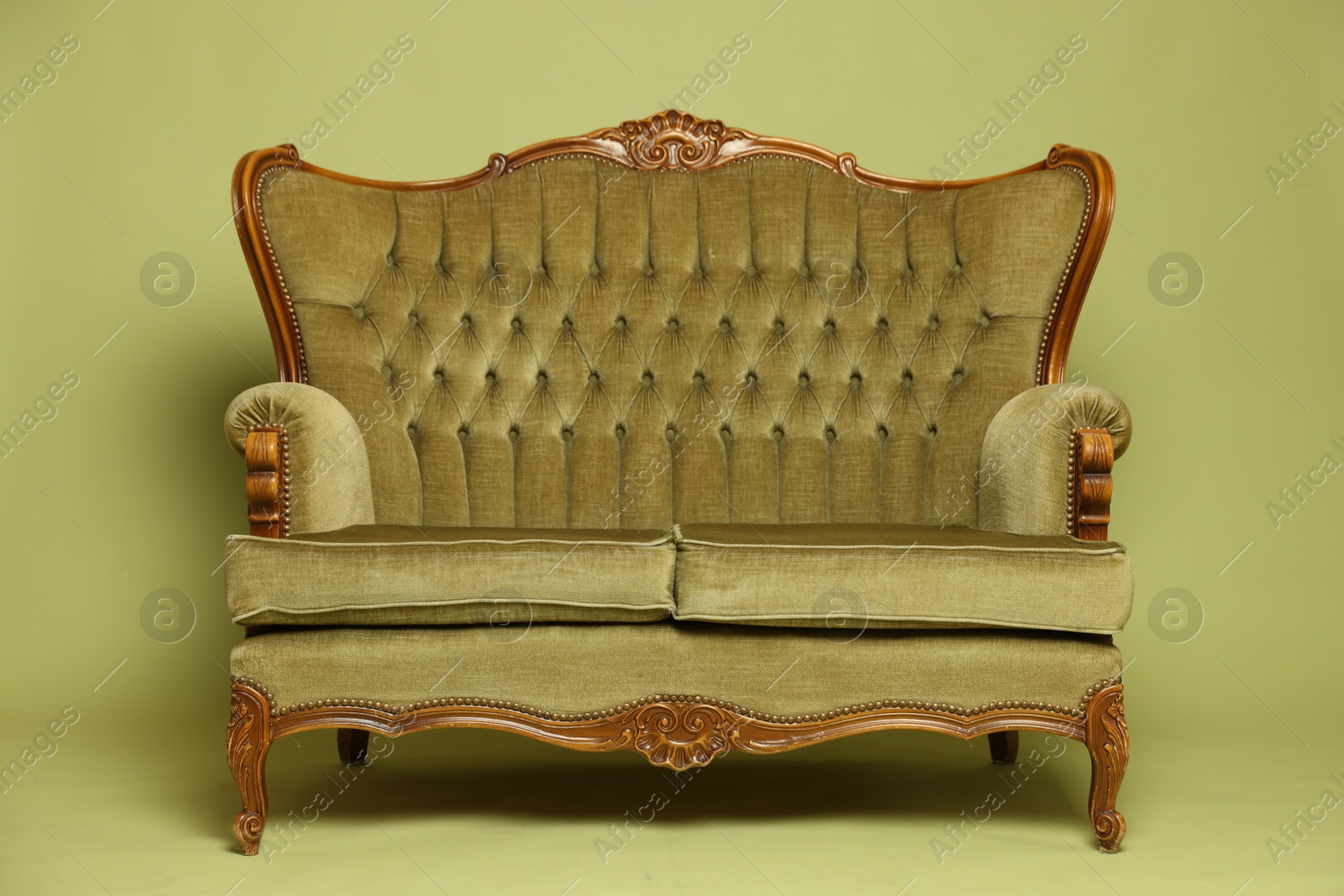 Photo of Soft sofa on olive background. Used stuff