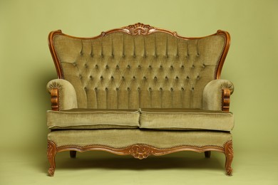 Photo of Soft sofa on olive background. Used stuff