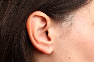 Photo of Sound. Closeup view of woman's ear and skin