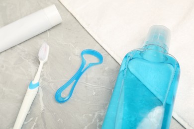 Photo of Mouthwash and other oral hygiene products on light marble table, closeup