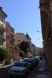 Photo of Nice, France - August 23, 2025: Beautiful buildings, trees and parked cars on city street