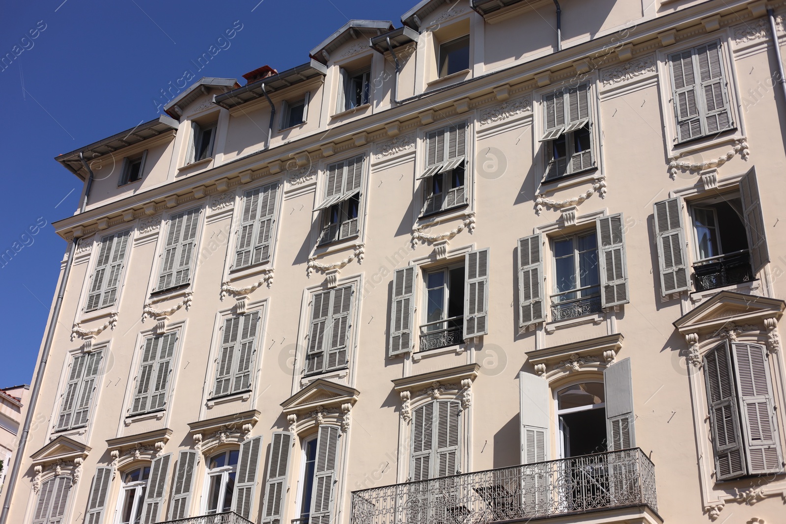 Nice, France - August 23, 2025: Beautiful building with windows and balconies against blue sky in city Photo of Nice, France - August 23, 2025: Beautiful building with windows and balconies against blue sky in city