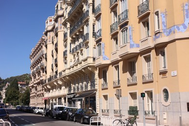 Photo of Nice, France - August 23, 2025: Beautiful building and parked cars in city