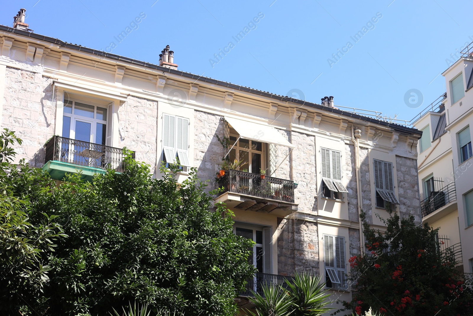 Nice, France - August 23, 2025: Beautiful building and trees in city Photo of Nice, France - August 23, 2025: Beautiful building and trees in city