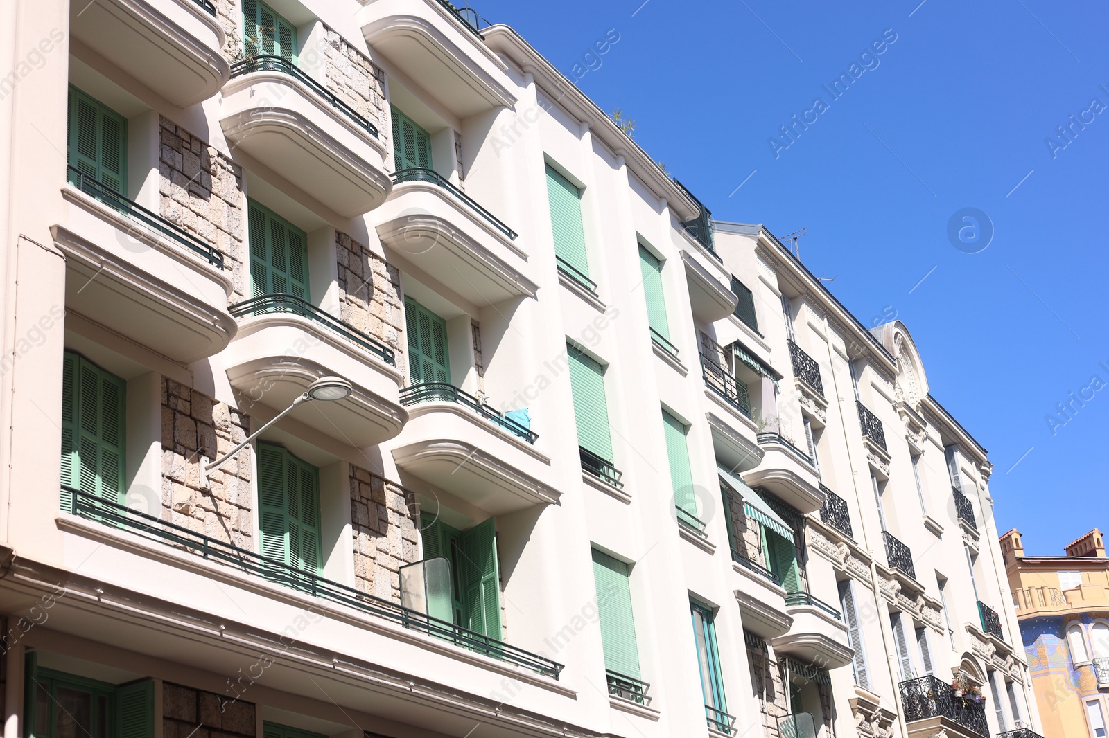 Nice, France - August 23, 2025: Beautiful building with windows and balconies against blue sky in city Photo of Nice, France - August 23, 2025: Beautiful building with windows and balconies against blue sky in city