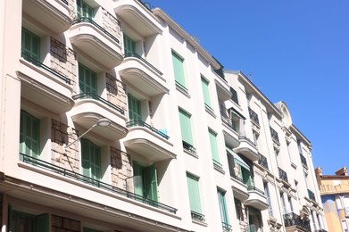 Photo of Nice, France - August 23, 2025: Beautiful building with windows and balconies against blue sky in city