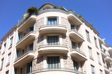 Photo of Nice, France - August 23, 2025: Beautiful building with windows and balconies against blue sky in city