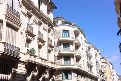 Photo of Nice, France - August 23, 2025: Beautiful building with windows and balconies against blue sky in city