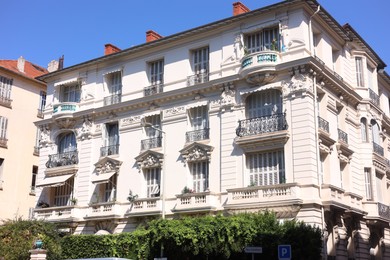 Photo of Nice, France - August 23, 2025: Beautiful building with windows and balconies against blue sky in city