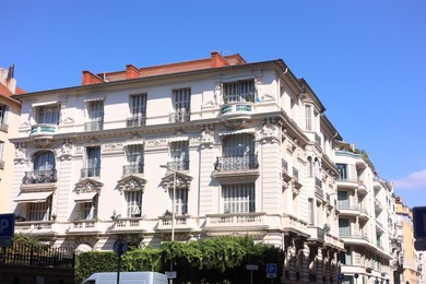 Photo of Nice, France - August 23, 2025: Beautiful building with windows and balconies against blue sky in city