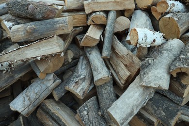 Photo of Pile of cut firewood outdoors, closeup view