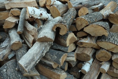 Photo of Pile of cut firewood outdoors, closeup view