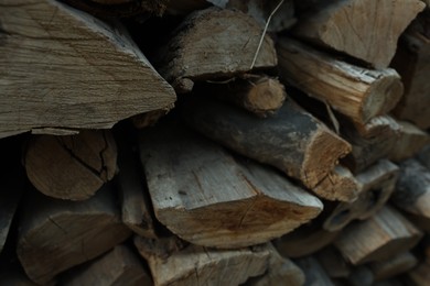 Photo of Pile of cut firewood outdoors, closeup view