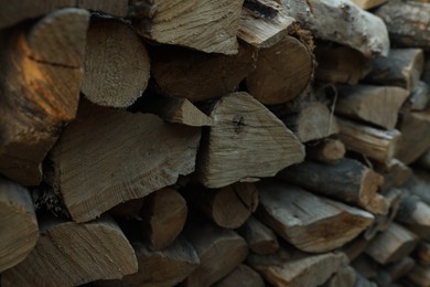 Photo of Pile of cut firewood outdoors, closeup view