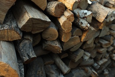 Photo of Pile of cut firewood outdoors, closeup view