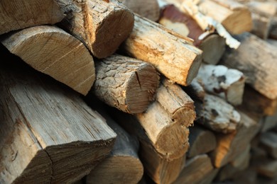 Photo of Pile of cut firewood outdoors, closeup view