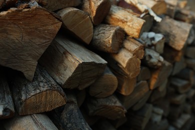 Photo of Pile of cut firewood outdoors, closeup view