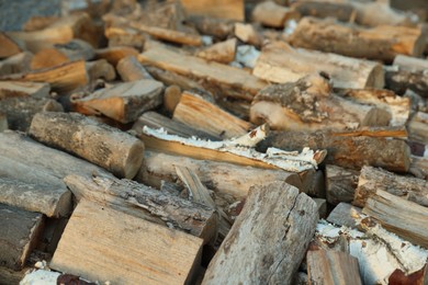 Photo of Pile of cut firewood outdoors, closeup view