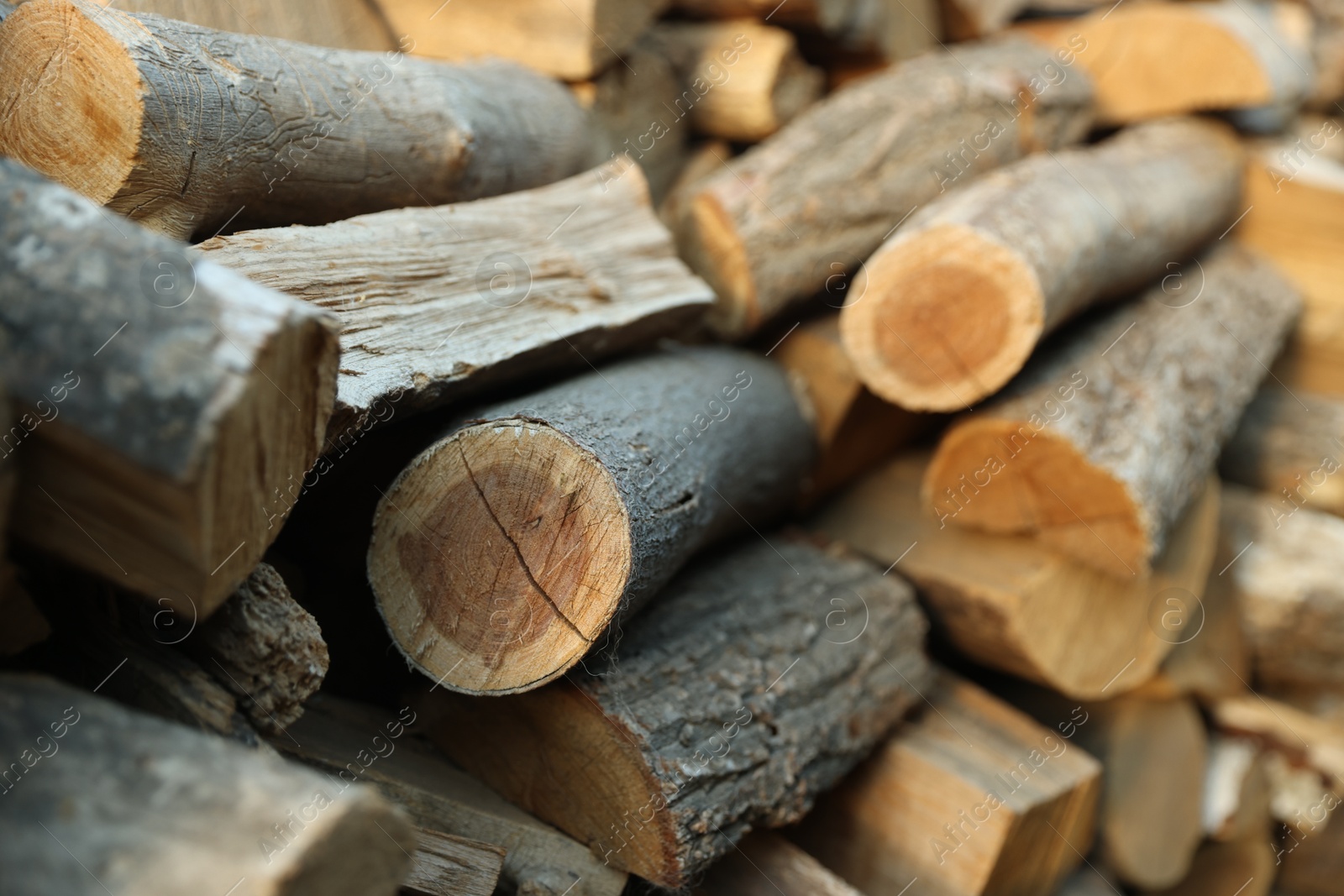 Photo of Pile of cut firewood outdoors, closeup view