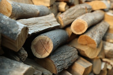 Photo of Pile of cut firewood outdoors, closeup view