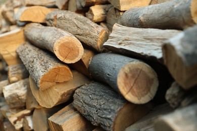 Photo of Pile of cut firewood outdoors, closeup view